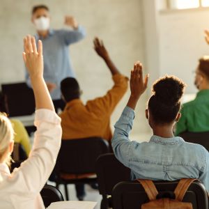 students with hands raised